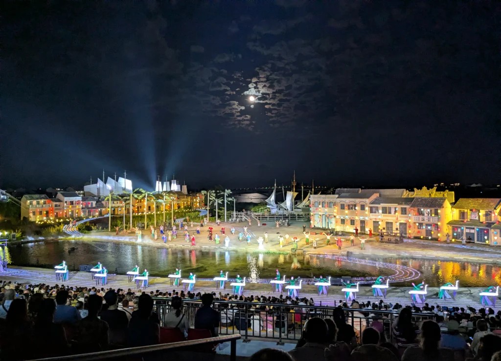 Audience watching a large outdoor cultural performance in Hoi An
