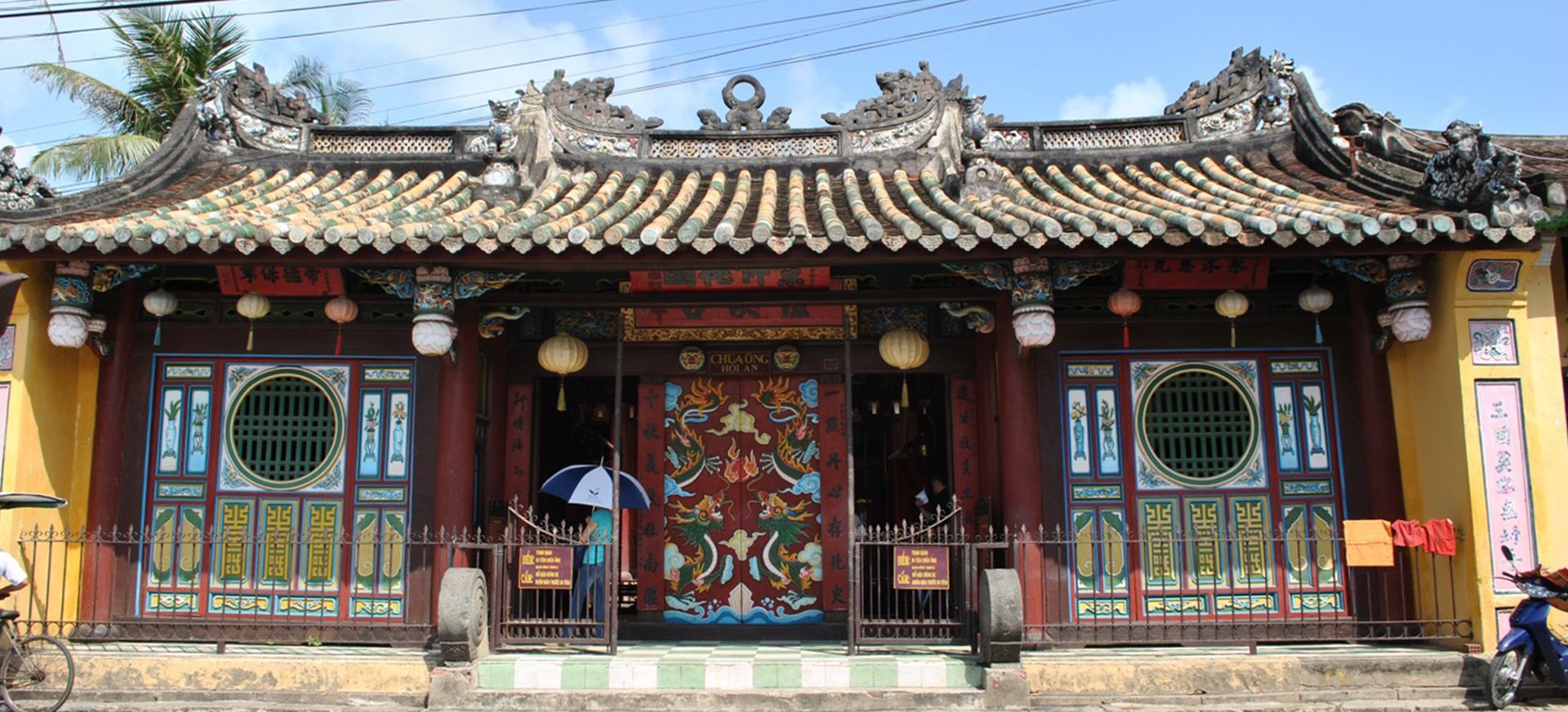 Colorful roof ornaments and detailed wooden carvings in a historic temple