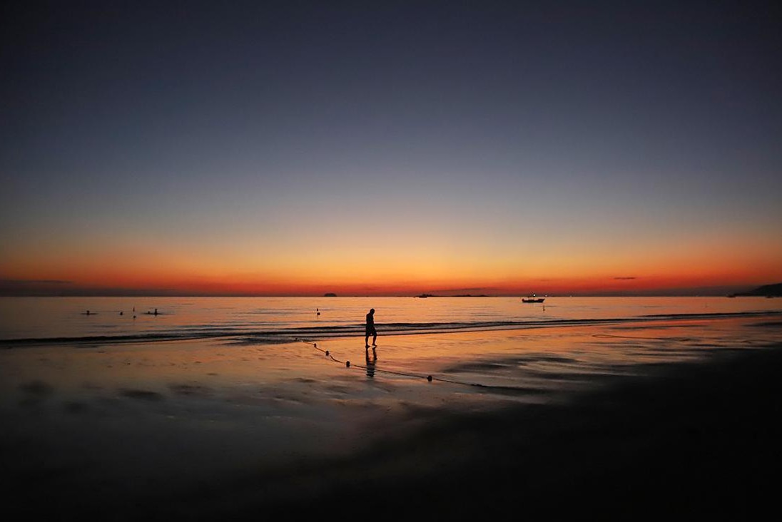 Early morning beach walk with soft sunlight and peaceful waves