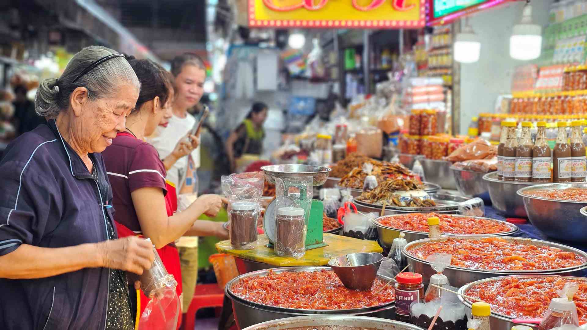 Early morning market scene with local shoppers and fresh produce
