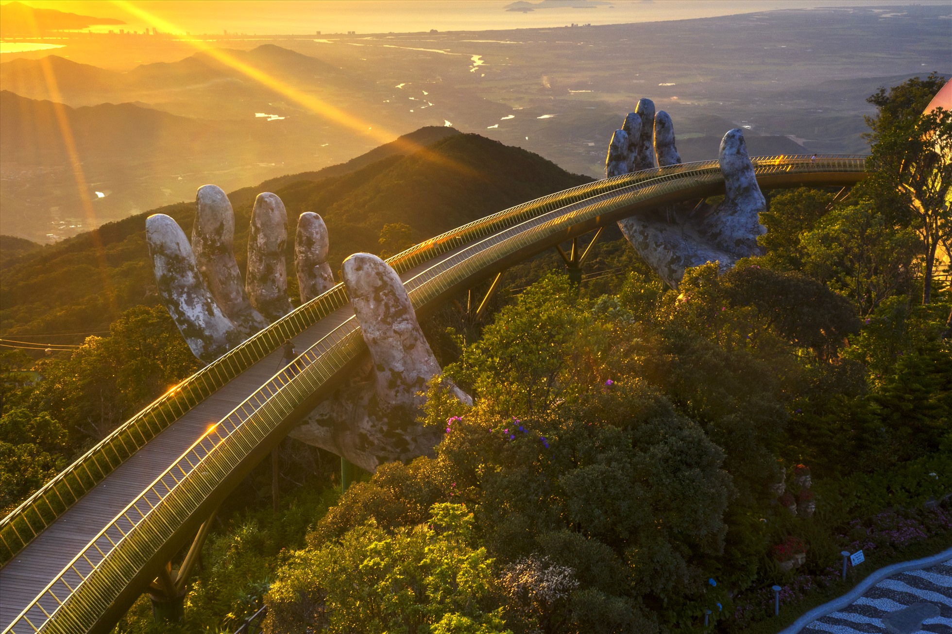 Giant stone hands holding a pedestrian bridge in Vietnam