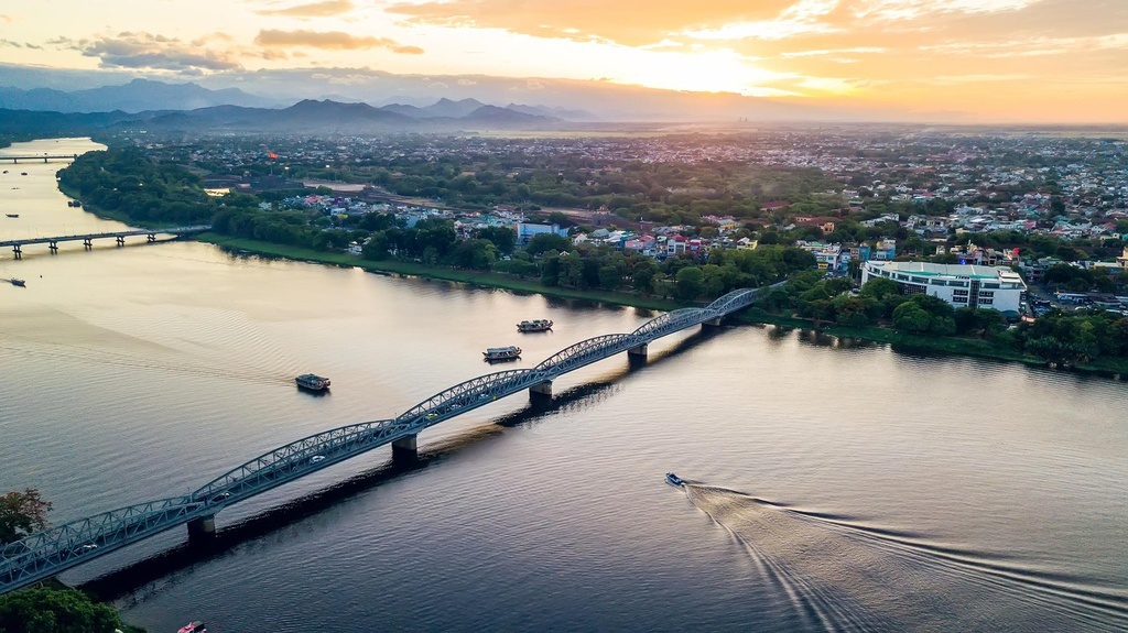 Hue city skyline with Perfume River and Truong Tien Bridge at sunset