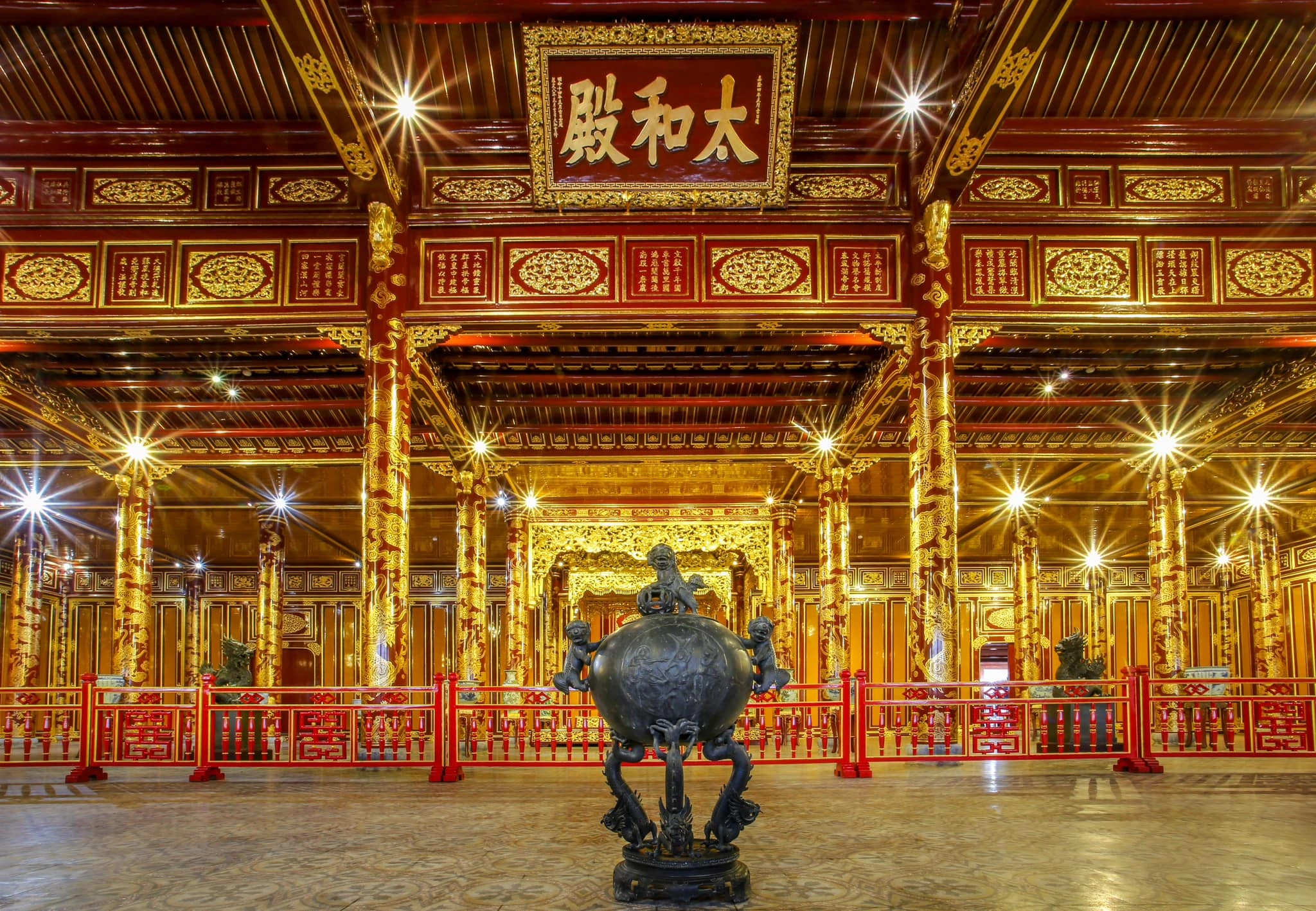 Interior of Thai Hoa Palace with lacquered wooden columns and dragon motifs