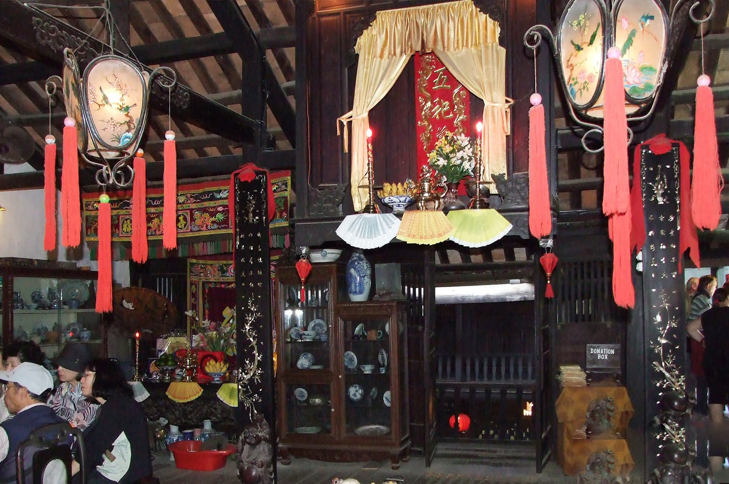 Intricate wood carvings and decorative motifs in a traditional Vietnamese house