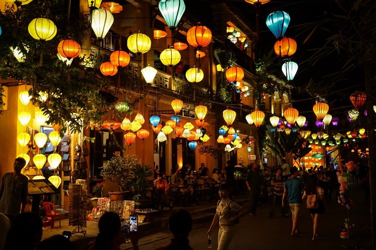 Lantern-lit streets and river reflections in Hoi An ancient town at night