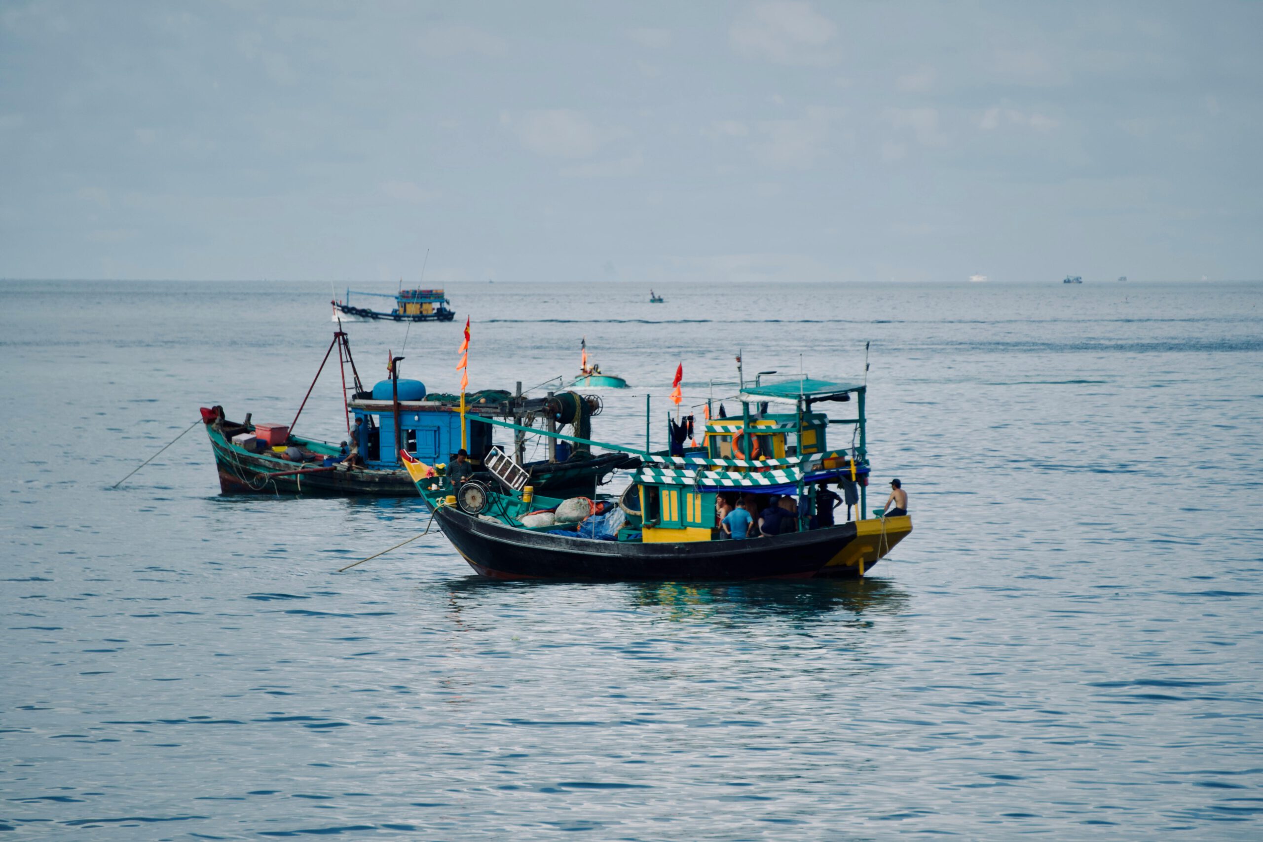 Quiet seaside scenery with fishing boats in the distance