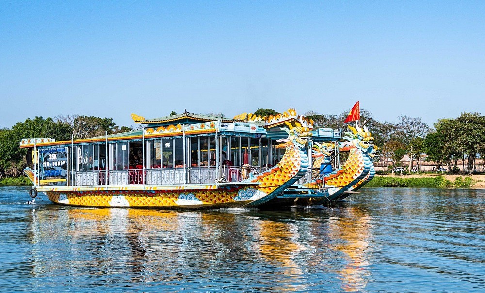 Traditional dragon boat cruising along the Perfume River
