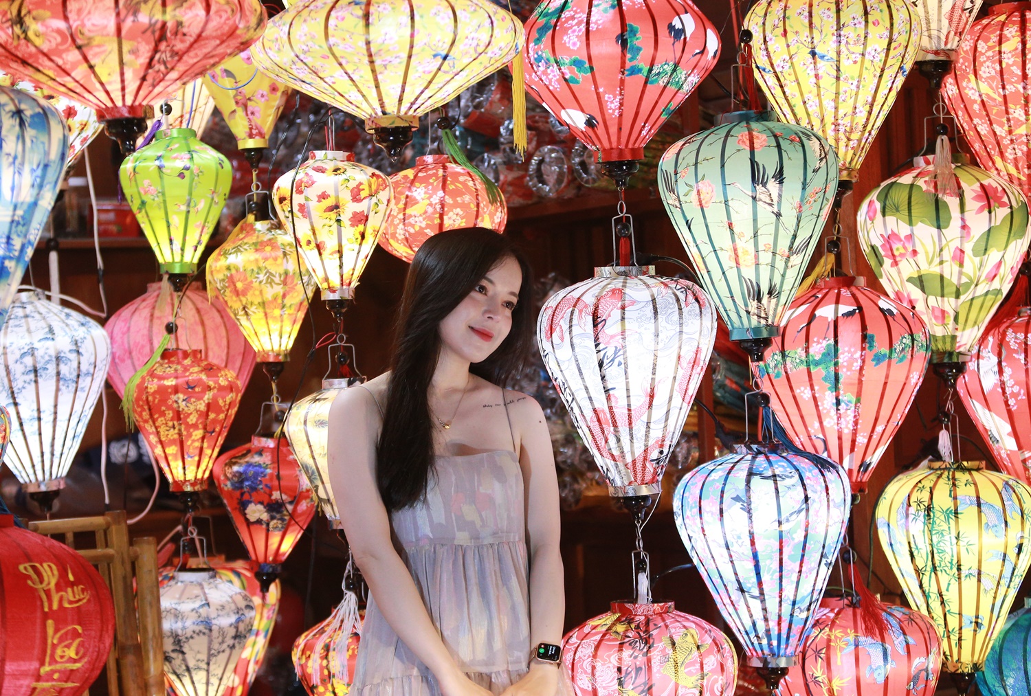 Travelers exploring lantern-lit streets in Hoi An during the evening