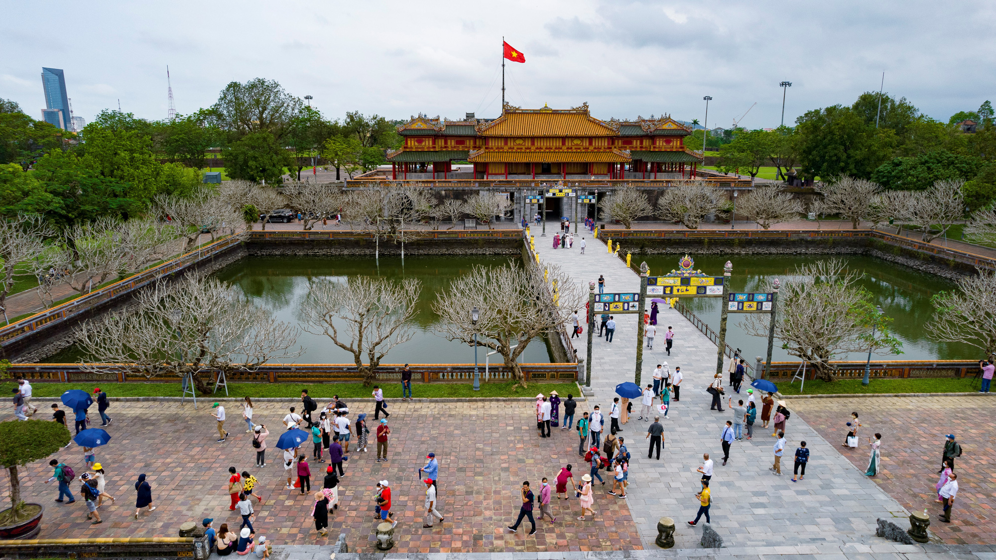Visitors exploring the historic complex during mild spring weather in Hue