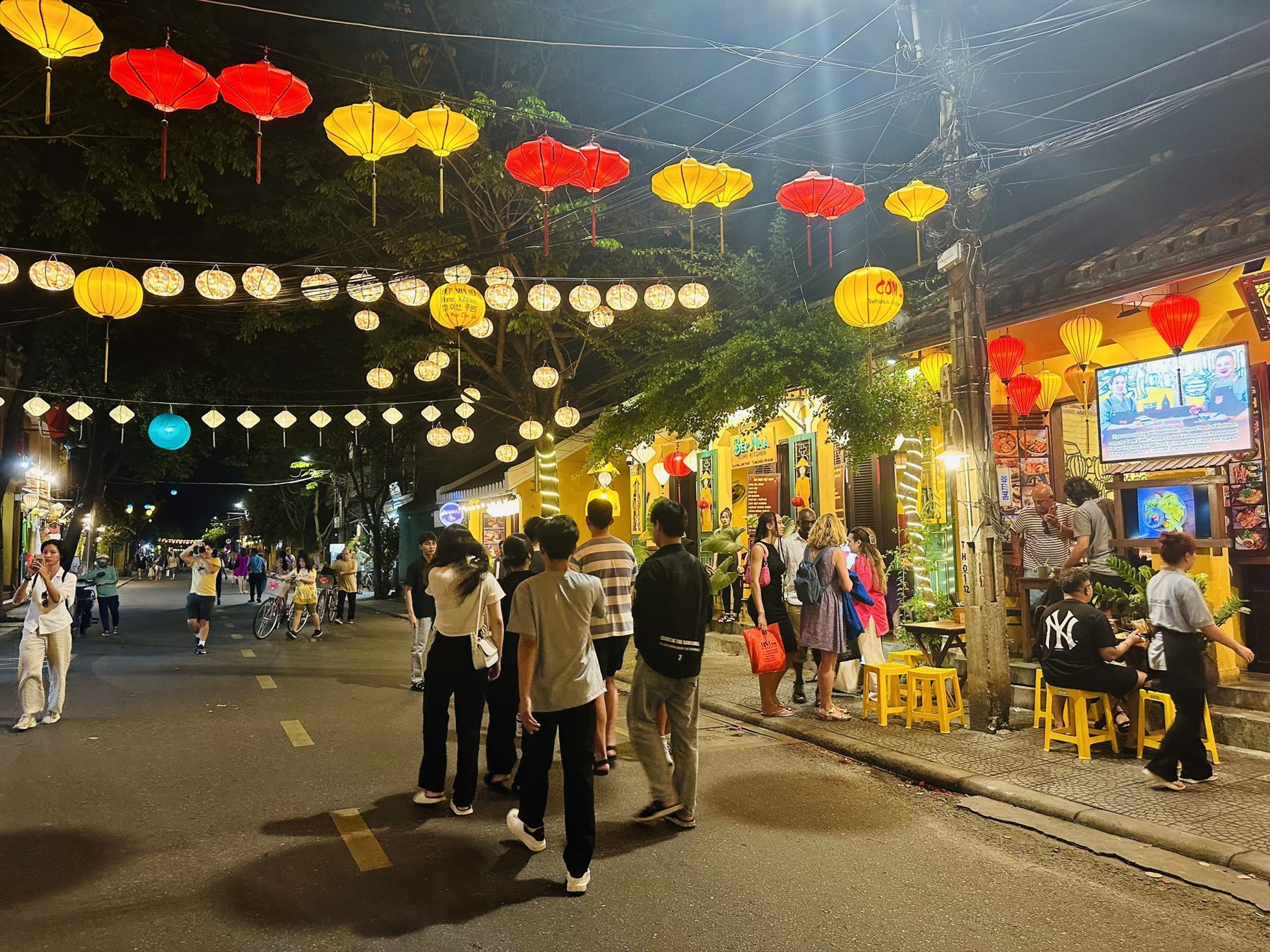 Visitors walking through a small street in Hoi An Old Town