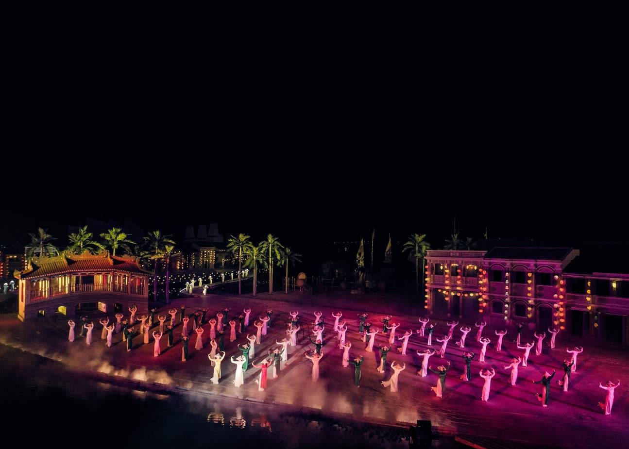 Visitors watching an outdoor night performance in Vietnam